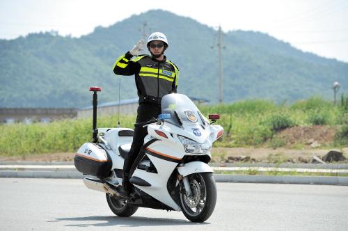 民警韦克杰表演在疾驰的警用摩托上“金鸡独立”、立姿驾驶等绝活。 均为长沙晚报记者 王志伟 摄
