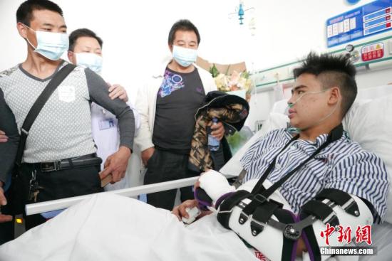 深圳滑坡灾害幸存者田泽明与父亲医院团聚。中新社记者 陈文 摄
