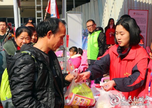 志愿者为返乡市民送上“爱心包”和《便民手册》