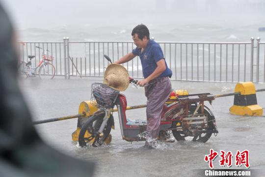 深圳市民雨水中艰难前行。 陈文 摄