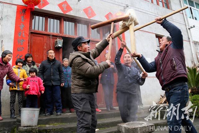 2月4日,溆浦县龙潭镇岩板村,村民在打糍粑.